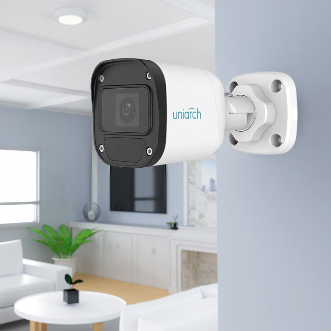 The image displays a "uniarch" branded security camera attached to a ceiling in a contemporary living space.