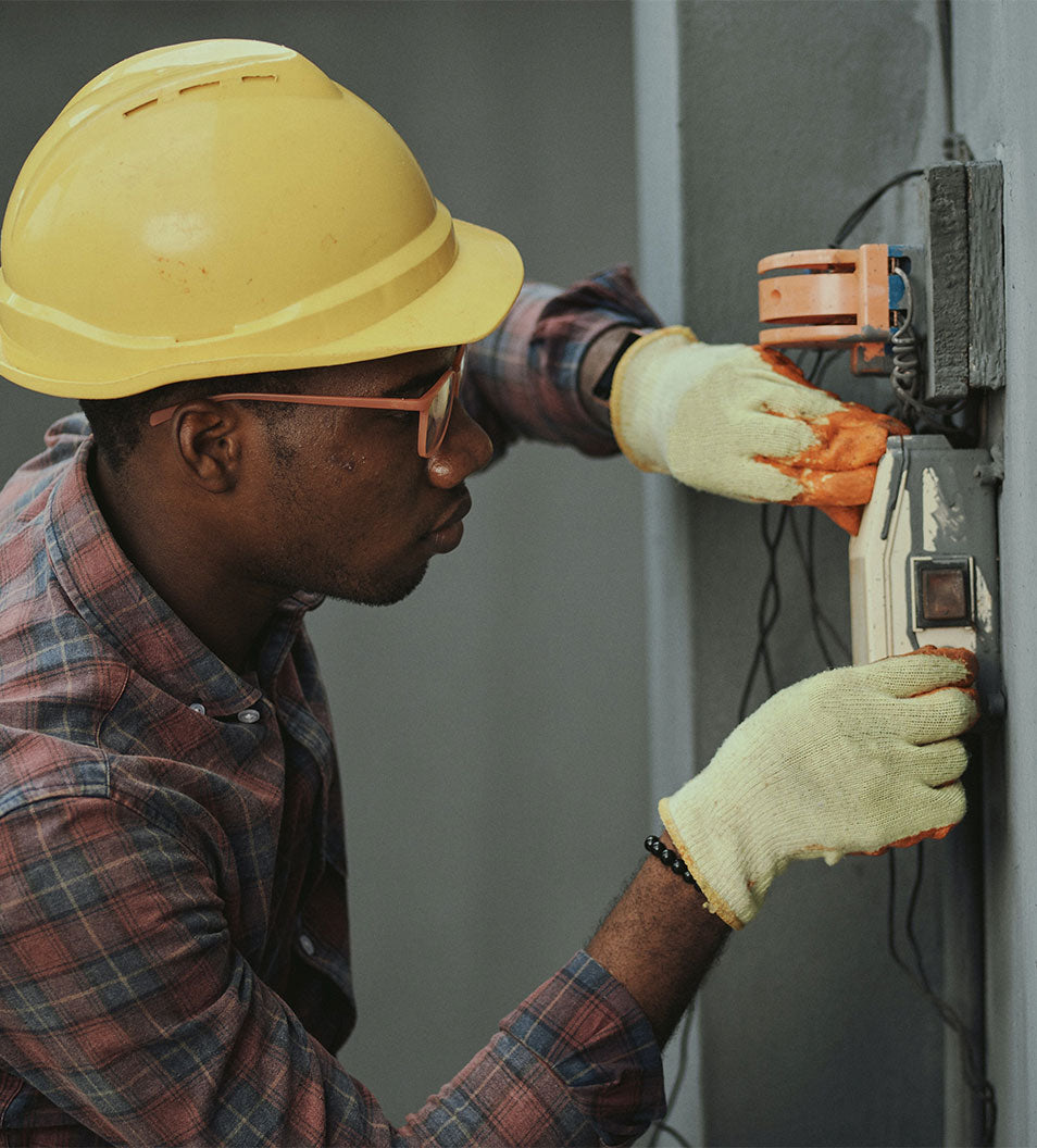 this is an electrician testing cables with safely equipment