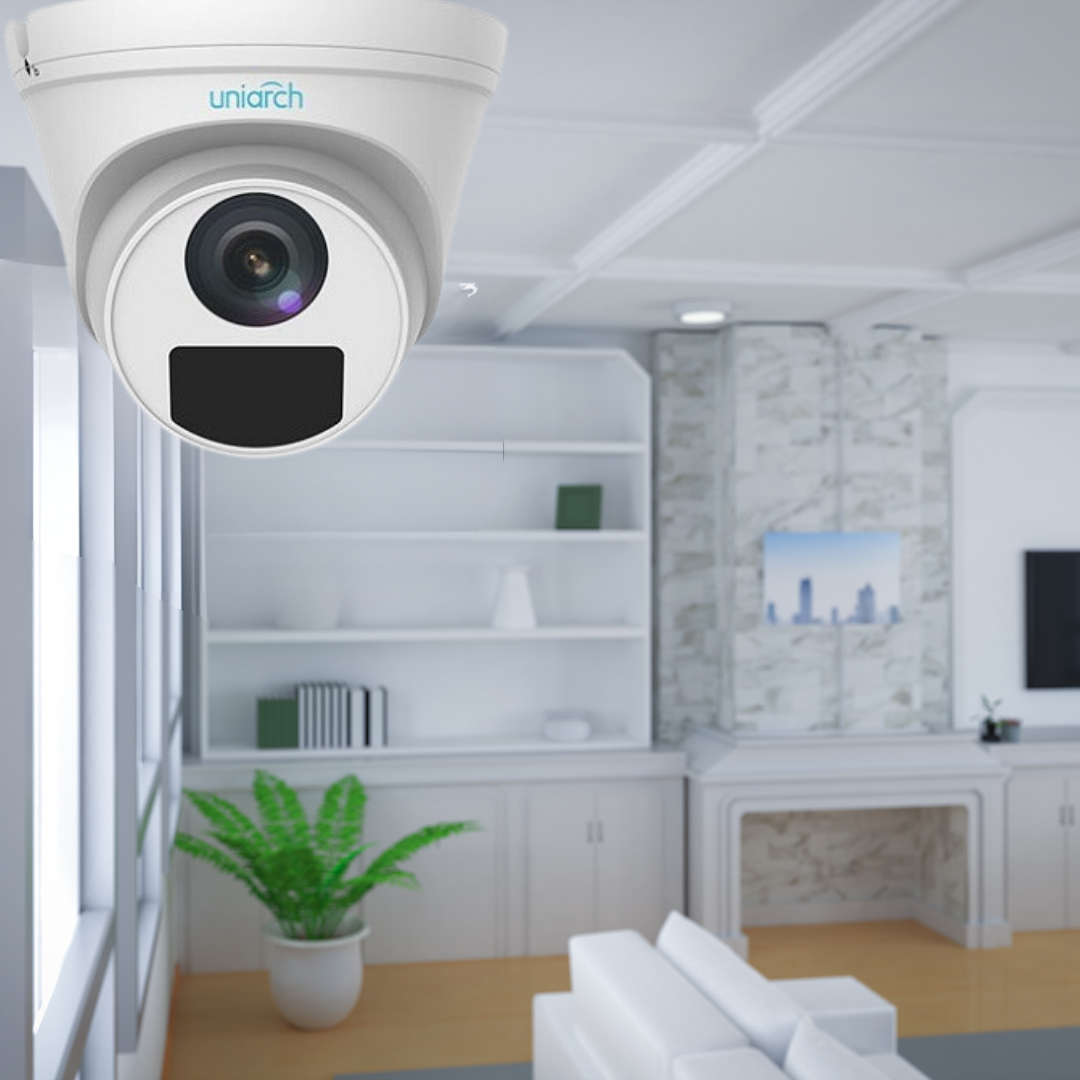 The image shows a "uniarch" branded security camera mounted on the ceiling of a modern room with white cabinetry, a fireplace, and minimalistic decor, highlighting the emphasis on security in this setting.